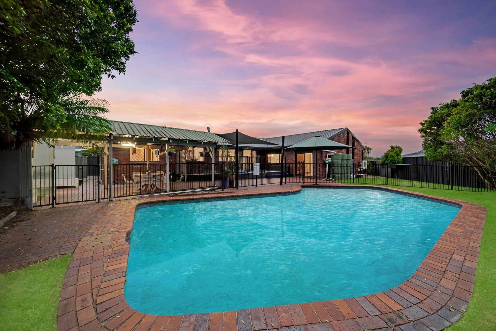 Swimming pool and garden under a twilight sky